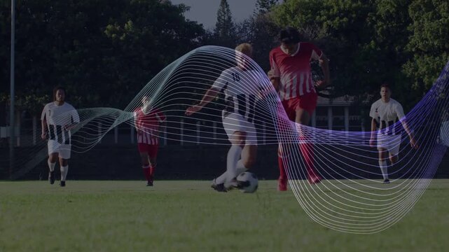 Red player pushing ball as defender closes, evading tackle, wave graphic over midfield sports