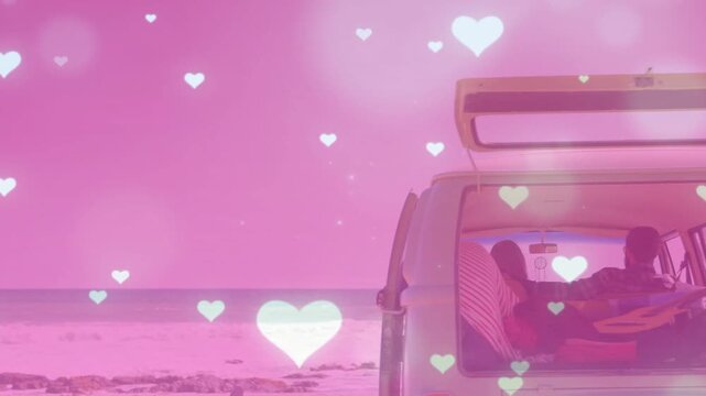 Travelers reclining in camper van by beach, ocean view urging guitar reaching, pink hearts floating