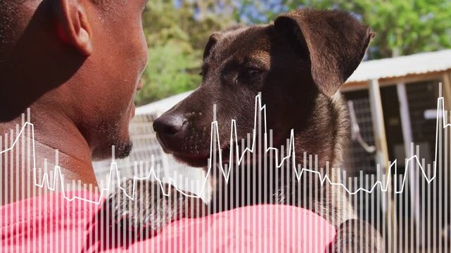 Man holding dog in shelter, causing nuzzling for comfort while waveform overlay mirroring movement