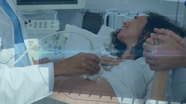 Pregnant woman holding spouse in ward, clinician applying gel starting scan, overlays showing fetus