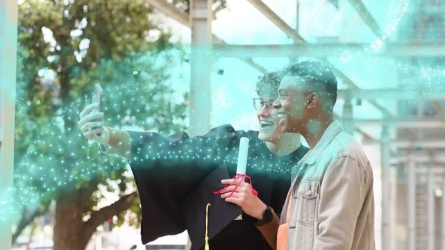 Grad taking phone selfie friend joining marking grad as teal overlay sweeping over gown and diploma