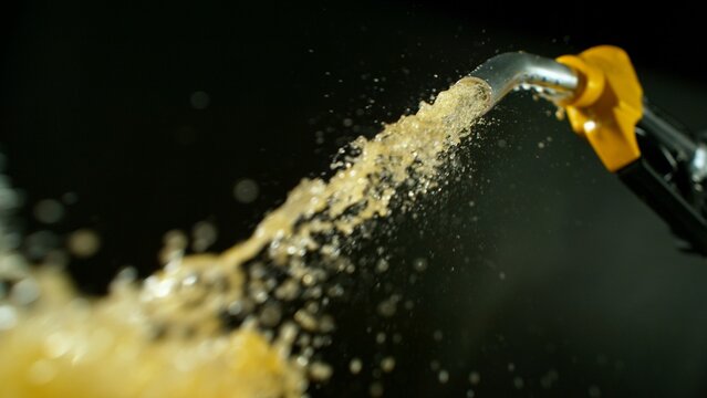 Close-up of Gasoline Spurting from the Gas Pump Nozzle