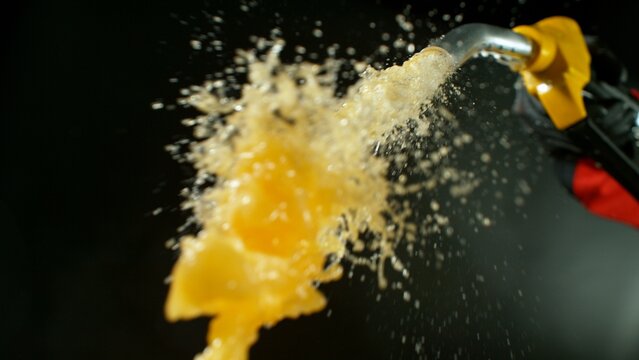 Close-up of Gasoline Spurting from the Gas Pump Nozzle