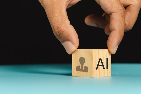 AI replacing traditional HR and the future of work. Wooden cube with AI text and human icon. Artificial intelligence replacing traditional HR roles, automation and the future of workforce management.