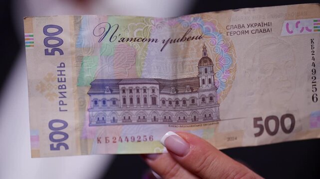 Reverse 500 Ukrainian hryvnia banknote, featuring a detailed portrait and visible security elements. The image captures financial concept, cash transaction, personal finance, economy.