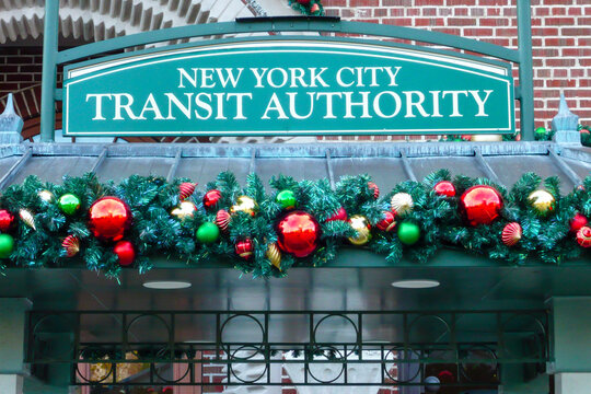 Entrance sign saying "New York City Transit Authority" with Christmas decorations.