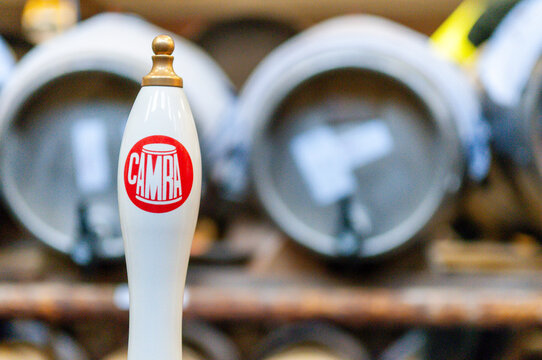 CAMRA beer pump with barrels behind