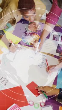 Vertical video: Design team placing color wheel, sketching while rotating globe guiding color picks