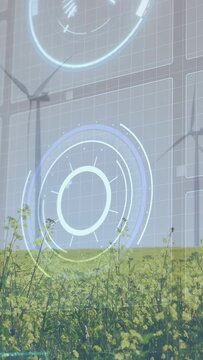 Vertical video: HUD activating rings glowing over horizon turbines turning crop swaying for data