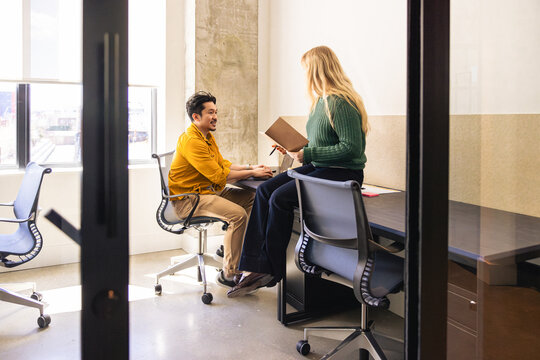 Young coworkers in discussion in modern office space