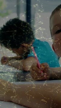 Vertical video: cam panning showing two boys learning, right boy using pink pencil, network overlay