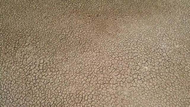 Abstract Texture of Fine Cracks on Dry Parched Ground Surface. Detailed Macro View of Dehydrated Soil Pattern During Severe Heatwave.