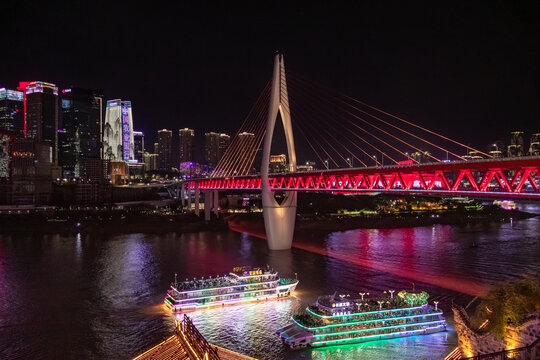 Night view if the iluminated Dongshuimen Twin River Bridge located on the Yangtze river sourrounded by colorful lit up buildings in Chongqing, China