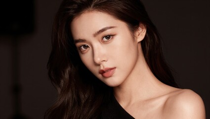 Fototapeta premium Young woman posing with neutral expression in studio portrait