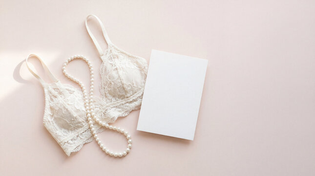 White lace bralette with pearl necklace beside blank card on soft pink background for feminine branding lingerie boutique promotion wedding styling beauty gift card mockup luxury retail campaign