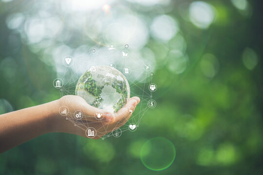 ESG icon concept in the hand for environmental, social, and governance in sustainable and ethical business on the Network connection on a green background.