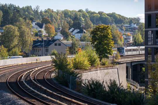 Oslo Norway metro train on railway tracks shows urban transit infrastructure supporting commute and sustainable transportation across the city