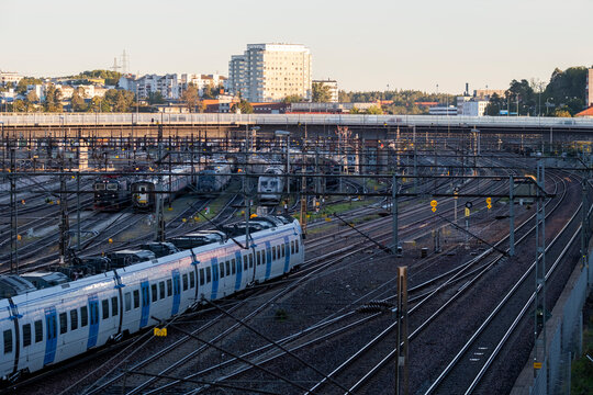 Urban transit railway scene in Stockholm Sweden as train follows tracks during commute highlighting infrastructure and modern transportation services