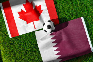 Obraz premium Canada vs Qatar, national flags before world championship Group B group stage match, football on green pitch with goal in the background, Vancouver, Canada, June 18, 2026