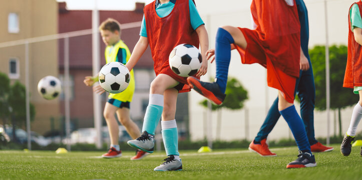 Youth Soccer Training Drill; Kids Practicing Ball Control with Multiple Balls in Air