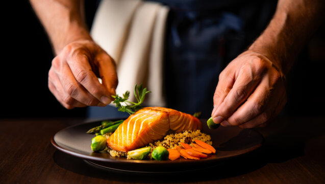 Chef plating a healthy meal with vegetables and sauce, restaurant kitchen, fine dining prep, culinary service, gourmet food.