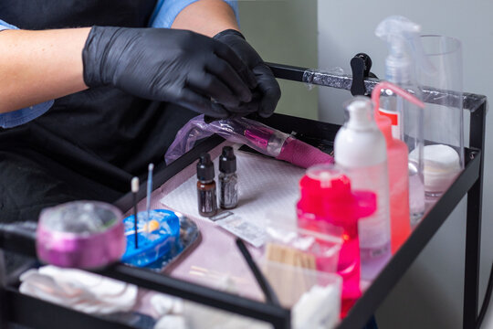 Close up of sterile workstation for permanent makeup, beautician preparing tools and pigments on tray in beauty salon