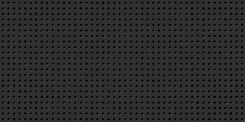 A seamless dark gray background featuring a dense pattern of small holes © Bibhas