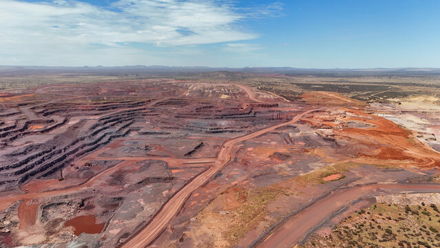 Drone aerial of open pit mining operation showing terraced excavation and haul roads in South Africa.