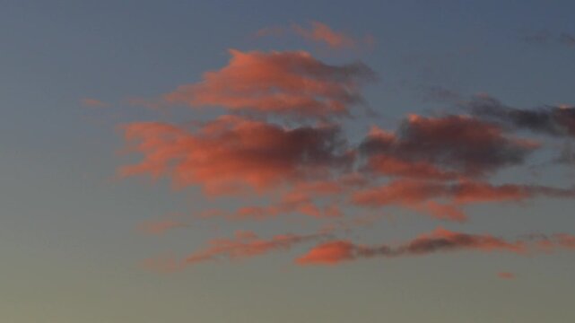 timelapse red cloud at sunset crumbles in blue sky
