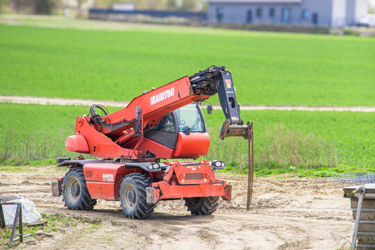 Poznan, Polska - April 23, 2026: Manitou telehandler positioned on a construction site