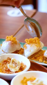Close Up of Person Eating Vietnamese Banh Beo Steamed Rice Cakes