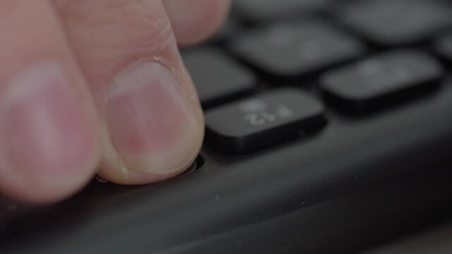 Closeup thumb pressing delete key, dark room and green glow, hacker initiates destructive command as monitor flashes red then green, sinister atmosphere, files vanish and breach