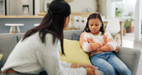 Listening, discipline and mom with girl on sofa for behavior, trouble and bad attitude in home....
