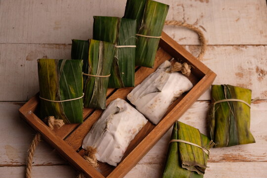 Raw tempeh or tempe. tempeh wrapped in banana leaves. Tempe is a traditional Indonesian food made from fermented soybeans.