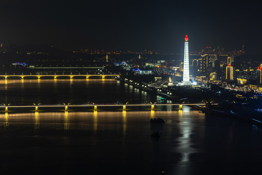 Juche Tower, Pyongyang morning panoramic view, North Korea. Taedong River in the morning fog. View facing upstream, modern residential complex. View from Yanggakdo Hotel