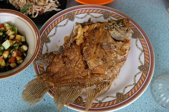 Fried gourami fish on the plate. Freshwater fish 
