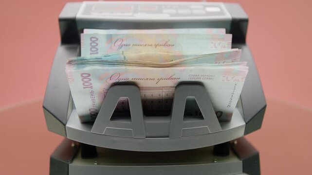 Money counting machine with Ukrainian hryvnia