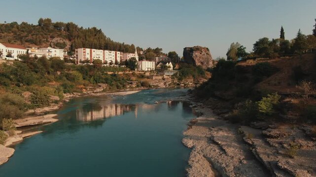 Aerial drone view of Permet cityscape and Vjosa river valley in Gjirokaster County, Albania showing the beautiful landscape