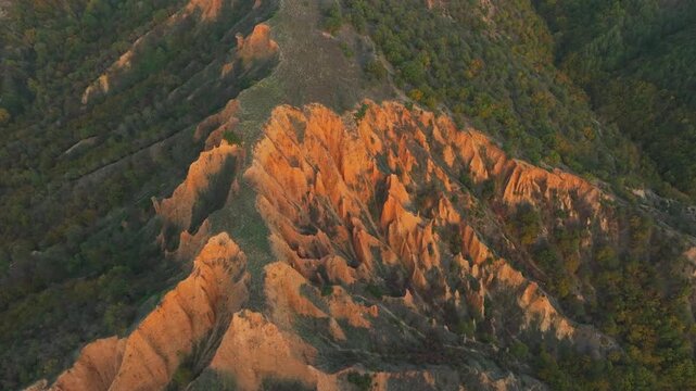 Stunning aerial perspective of the Stob pyramids in Bulgaria. The drone slowly circles the unique sandstone formations illuminated by sunrise