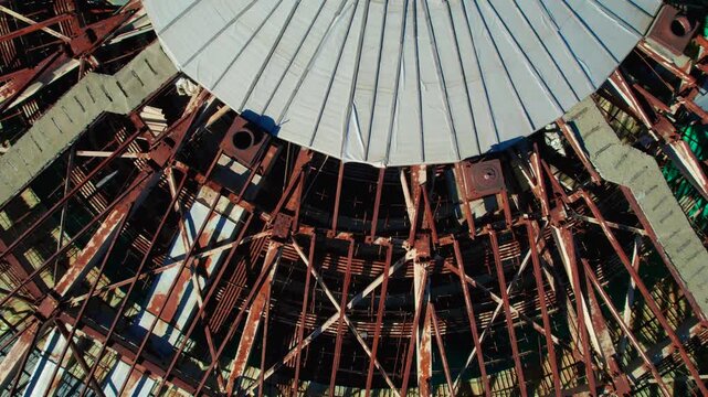 Buzludzha Monument's decaying dome and rusty metal framework revealing its soviet era brutalist architecture from above in Bulgaria