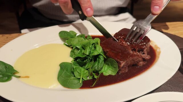 Oxtail with truffled Parmentier and a Montsant red wine sauce with with mashed potatoes and spinach. High quality 4k footage