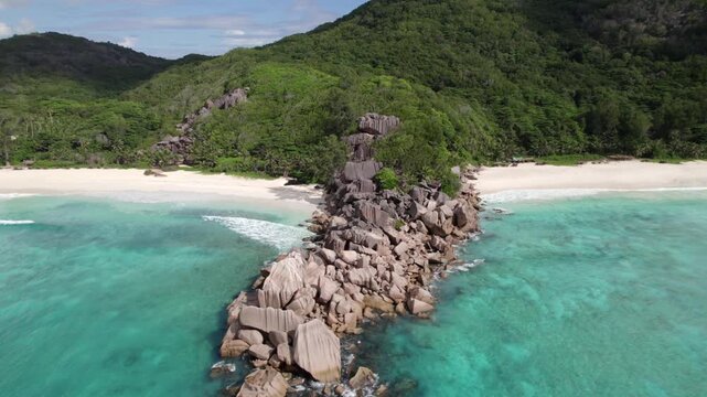 Drone of amazing nature from grand anse beach and petite anse, granite stones along water, crushing waves, untouched nature, La Digue, Seychelles 30fps 004.