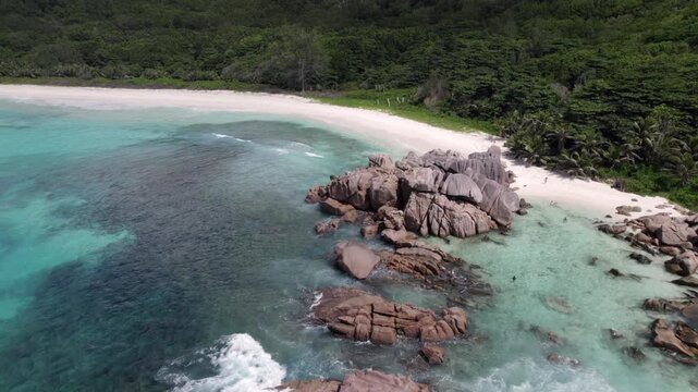 Drone flying near grand anse beach, granite stones, white sandy beach, untouched nature, La Digue, Seychelles 30fps 015
