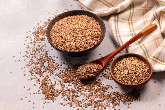 Flaxseed and linseed in wooden bowls with spoon