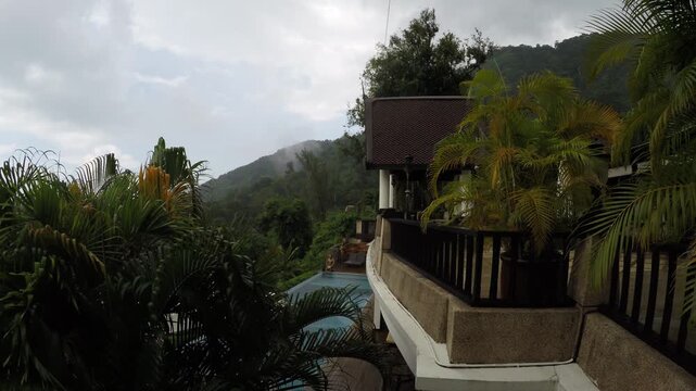 Raining View of Tropical resort view with mist rolling over jungle hills