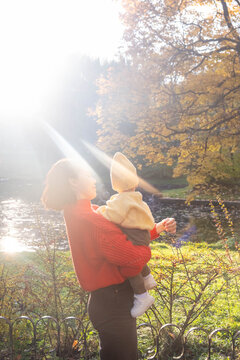 Portrait Mother and Baby Smiling in Autumn Park