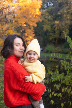 Portrait Mother and Baby Smiling in Autumn Park