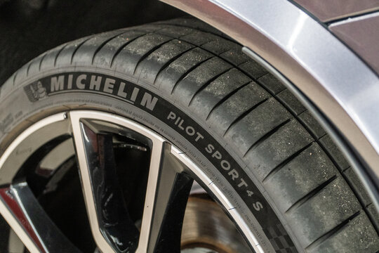 Michelin Pilot Sport 4S Tires wheel close up on black car. Michelin Pilot Sport summer model tire logo close up view. Michelin is a French tire manufacturer based in France.