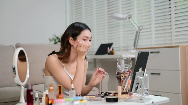 Beauty influencer creating makeup tutorial with skincare routine, product review and viral content filming in home studio