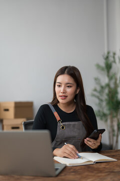 Young woman managing small business and online orders
